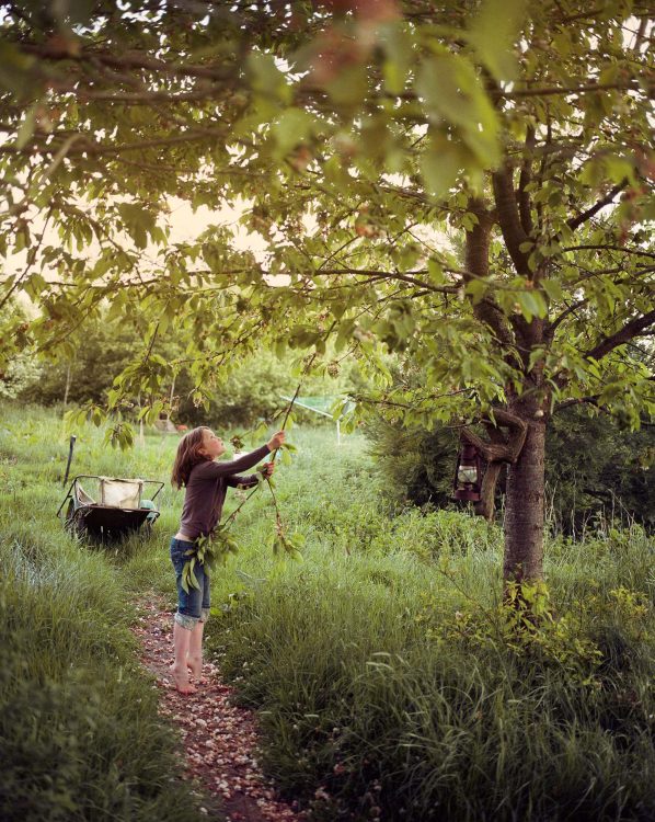 Girl plays in the garden. Somerset, UK