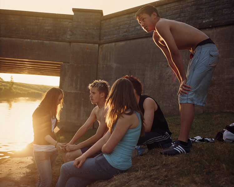 Teenagers hang out by the river. Somerset, UK